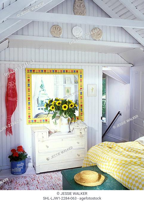 BEDROOM - Vacation home. Painted white chest, mirror with yellow frame and stylized tulips, sunflowers in white antique pitcher, straw hat