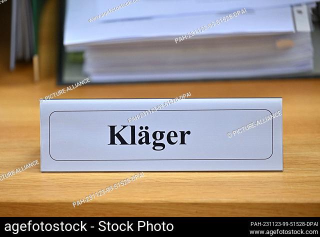 23 November 2023, Brandenburg, Cottbus: A sign reading ""Plaintiff"" stands in a room at Cottbus Administrative Court before the start of the hearing for the...