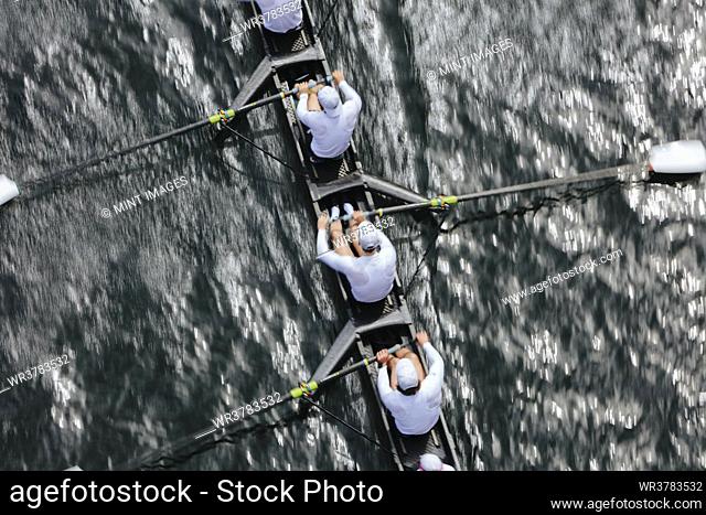 Overhead view of female crew racers rowing in an octuple racing shell, an eights team