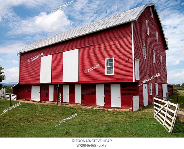Traditional US red painted barn on farm