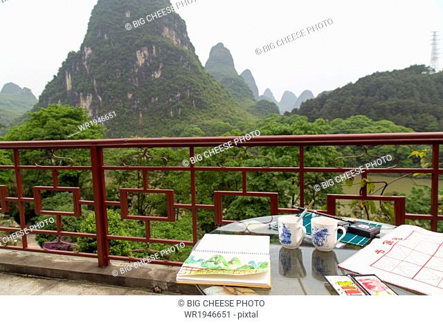 Watercolor materials on a patio overlooking the Karst mountains, Yangshuo, China
