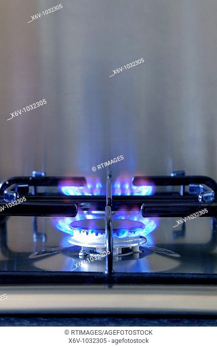 Two gas rings alight on a modern brushed steel hob