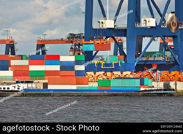 Cargo containers loaded on ships in a container terminal in Rotterdam