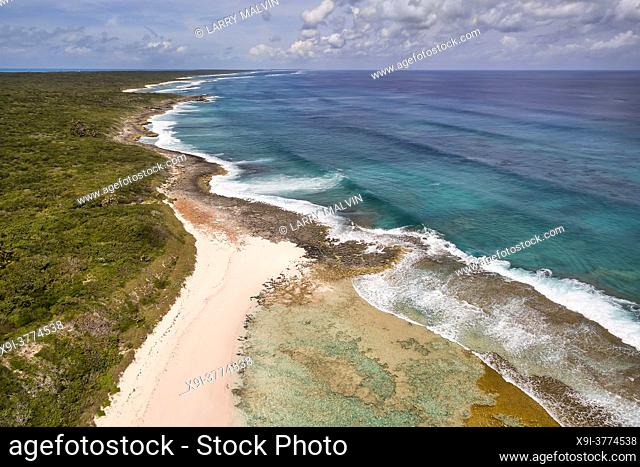 Aerial view of a desolate shoreline and coral formations along the Atlantic Ocean side of Cat Island, Bahamas
