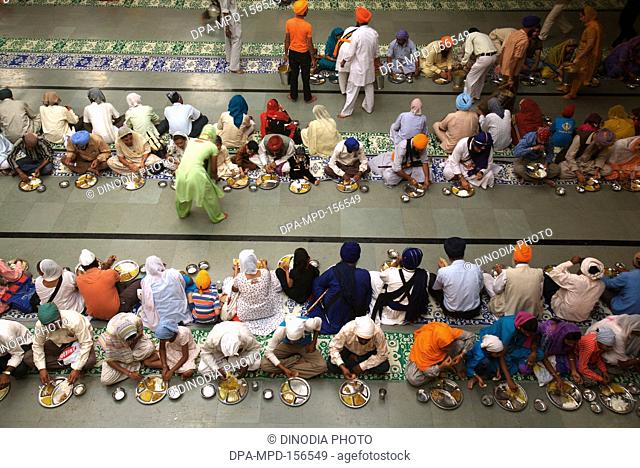 300th year of consecration of Guru Granth Sahib on 30th October 2008 ; Sikh devotees having food at a Langar (traditional community kitchen) at Sachkhand Saheb...