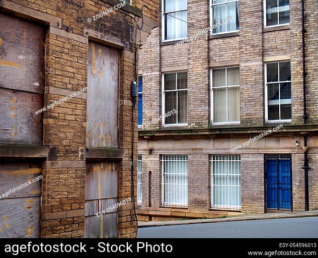 a street corner view of closed and boarded up old abandoned industrial and office buildings in the little germany area of bradford