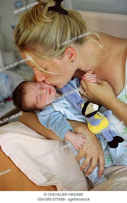 Woman kissing her baby