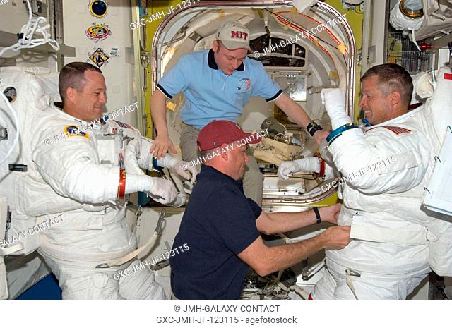 Astronauts Steve Swanson (right) and Richard Arnold, both STS-119 mission specialists, attired in their Extravehicular Mobility Unit (EMU) spacesuits