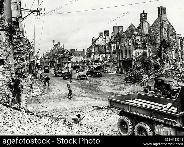 World War II - FRANCE. Invasion of Normandy 1944, 1st Army Trucks and Jeeps in Ruins of Isigny Normandy 1944. The D-Day landings of 6 June 1944 saw the Allies...
