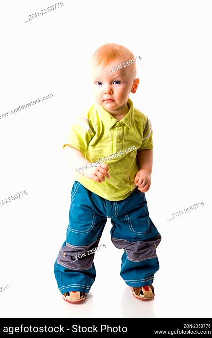 One year boy standing on floor isolated on white