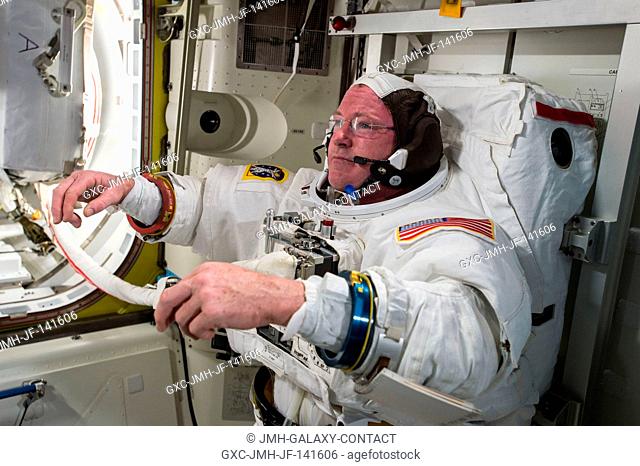 U.S. astronaut Barry Butch Wilmore checks out his spacesuit in preparation for an extravehicular activity (EVA) or spacewalk