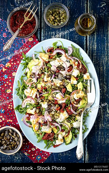 Salad with avocado, dried tomatoes and feta