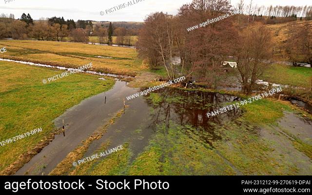 12 December 2023, Saxony-Anhalt, Tanne: Meadow areas are partially under water in the Upper Harz near Tanne. (Photo taken with a drone)