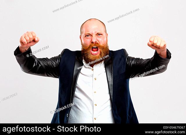 Evil screaming man with hands up on clean gray background