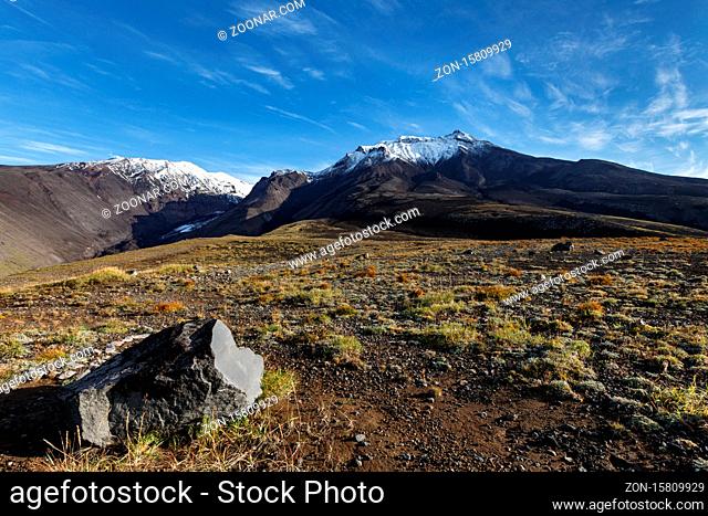 Panoramic volcanic landscape of Kamchatka Region: autumn view of Kozelsky Volcano on background of blue sky. Avachinsky-Koryaksky Group of Volcanoes