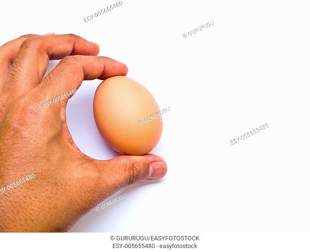 Man's hand with an egg isolated on white background