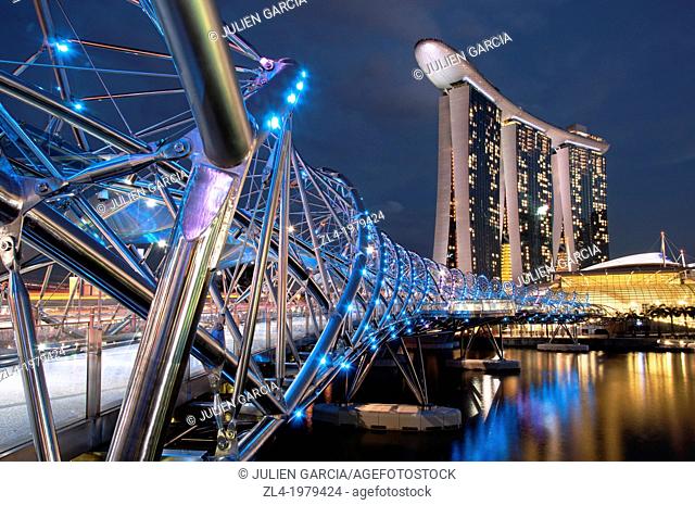 Marina Bay Sands hotel designed by the architect Moshe Safdie in the evening, viewed from the Helix bridge. Singapore, Marina Bay