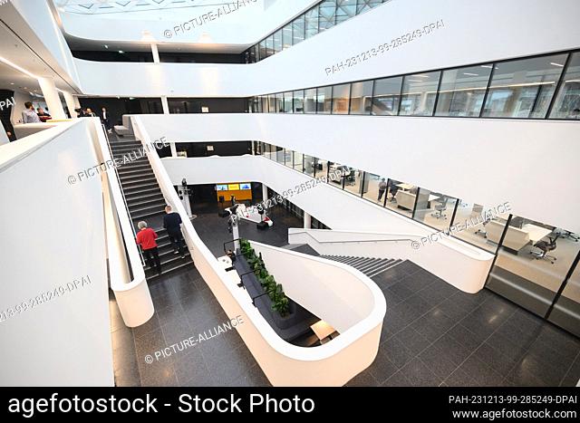 13 December 2023, Lower Saxony, Hanover: Employees walk through Continental's new corporate headquarters. After several years of construction