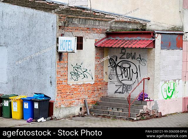 18 January 2023, Poland, Slubice: A sign ""Hotel"" is attached to a house in need of renovation and painted with graffiti in Maja Street