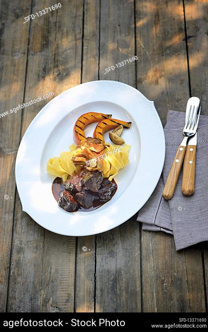 Wild hare stew with grilled pumpkin wedges and tagliatelle