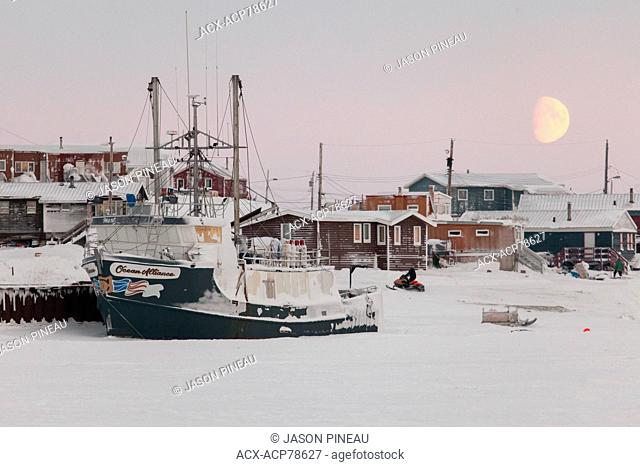 A ship sits docked for the winter in Cambridge Bay, Nunavut, Canada