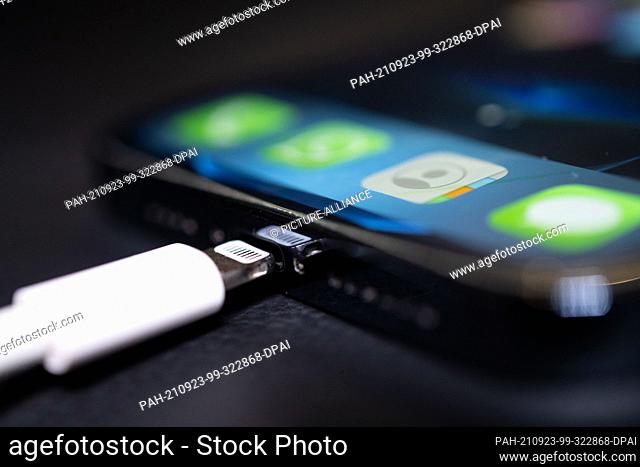 22 September 2021, Lower Saxony, Oldenburg: A Lightning charging plug is inserted into an Apple iPhone. The EU Commission presents a proposal for a uniform...