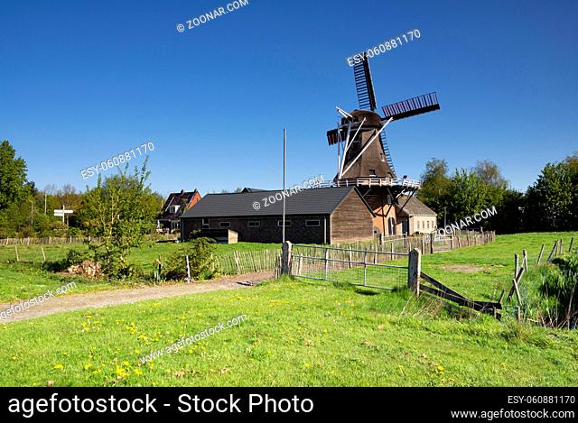 Windmill the Feanstermoune in the Frisian village Surhuisterveen