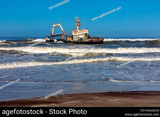 Abandoned and derelict old shipwreck Zeila at the Coast near Swakopmund, famous Skeleton Coast, Africa, Namibia. Group of cormorants birds perching on rusted...