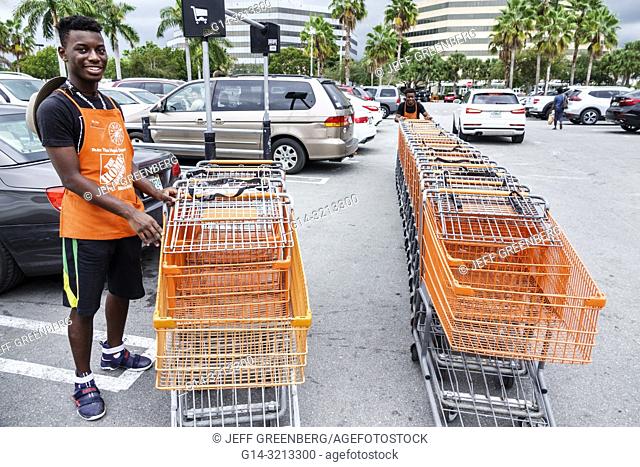 Florida, Miami, The Home Depot, inside, hardware big box store, Black, teen, boy, employee job working, gathering returning shopping carts from parking lot