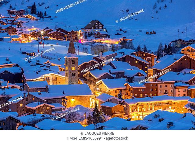 France, Savoie, Val D'Isere, view of the village and Saint Bernard de Menthon Church with a squared Lombard bell tower at dusk, massif de la Vanoise