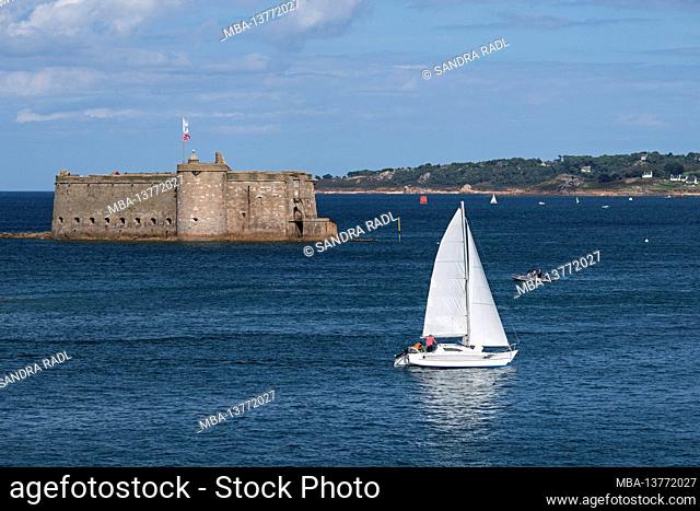 Sailboat in front of Château Taureau near Carantec in the bay of Morlaix, France, Brittany, Finistère department