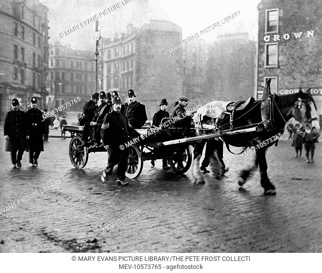 Policemen escorting a cart to the docks during riots in Dundee, Scotland. Strikers trying to prevent the delivery of coal fought with the police and rioted:...