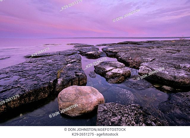 Dawn skies and shoreline limestones at Mississagi Point, Mississagi Lighthouse, Manitoulin Island, Ontario, Canada