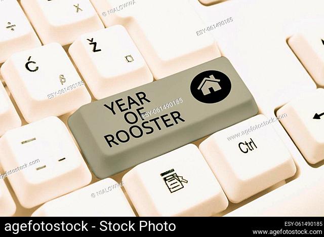 Conceptual caption Year Of Rooster, Word Written on Chinese horoscope zodiac sign China traditional celebration Businessman in suit holding open palm...