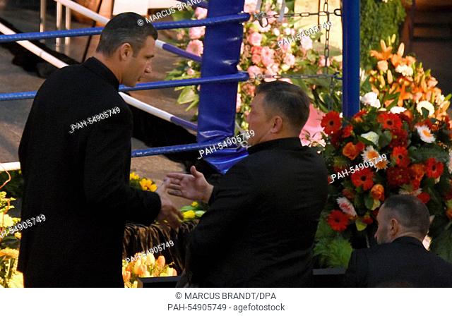 Former boxing pros and world champions Dariusz Michalczewski (R) and Henry Maske shake hands during the funeral service of late boxing coach Fritz Sdunek in...