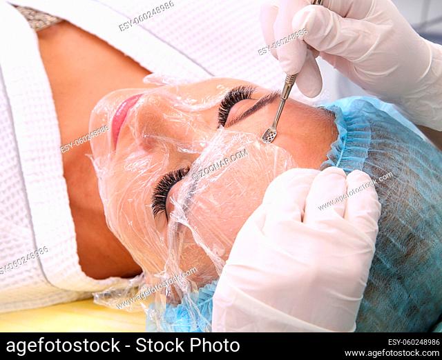 Cosmetologist at spa beauty salon doing acne treatment using mechanical instrument. Concept of medical treatment of rejuvenation and skincare