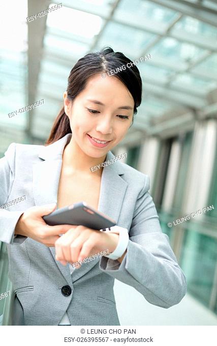 Business woman use of smart phone and watch