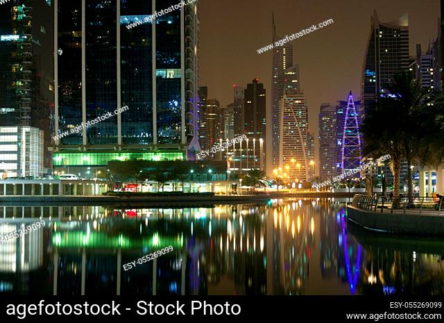 Dubai, United Arab Emirates - April 25, 2018. High skyscrapers of the business city centers, located near the seaport. Night time urban landscape