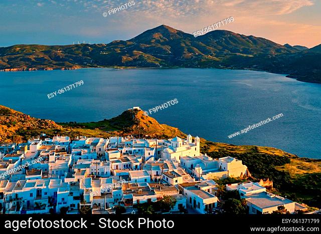 View of Plaka village on Milos island with traditional greek white houses on sunset. Plaka town, Milos island, Greece