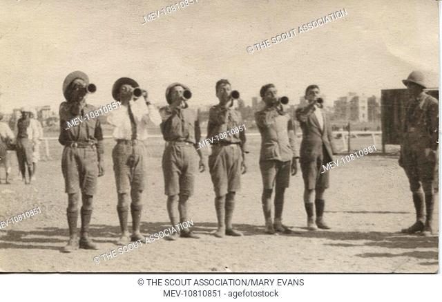 Armenian boy scouts blowing 'cook house' at the Armenian refugee camp, Heliopolis, near Cairo, Egypt. The camp was formed during the Egyptian Riots of June 1919...