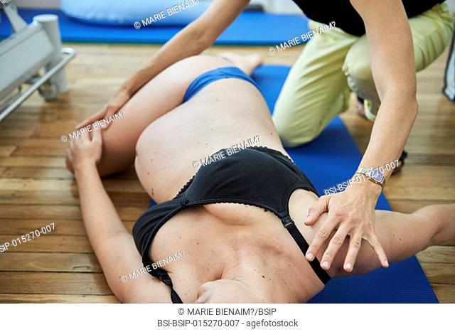 Reportage in a physiotherapy practice in Lyon, France. The physiotherapist teaches a pregnant woman exercises to strengthen her perineum in order to maintain...