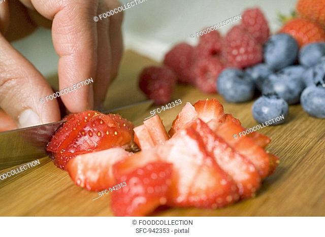 Cutting strawberries into pieces