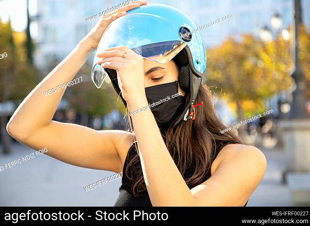 Close-up of young woman wearing helmet