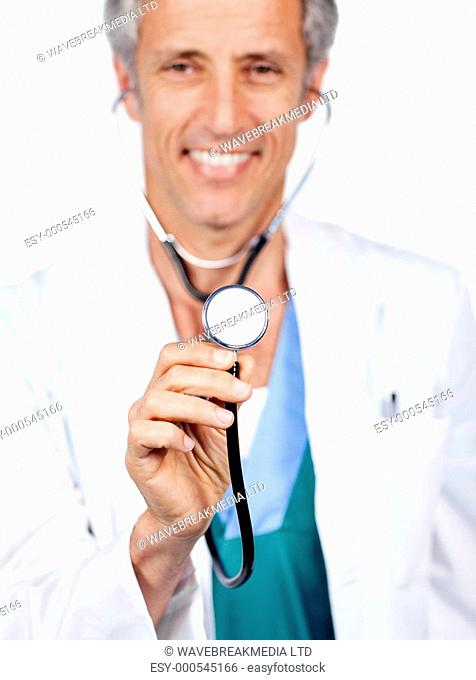 Attractive doctor presenting his stethoscope against a white background