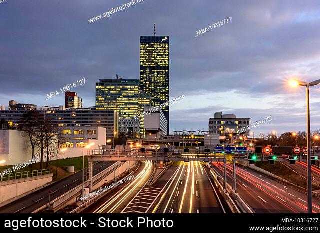 Wien, Vienna: freeway Donauuferautobahn A22, Donaucity, DC Tower 1, cars, light tracks in 22. Donaustadt, Wien, Austria