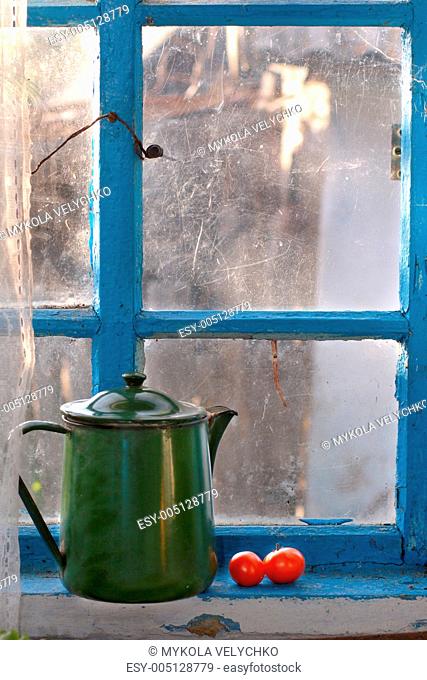 Old teapot on a window sill