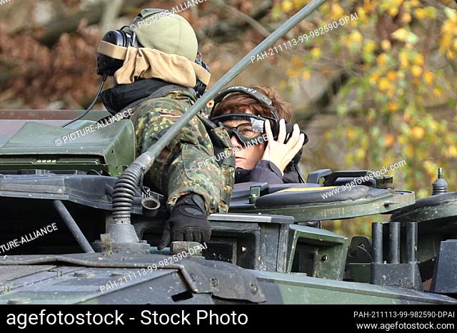 09 November 2021, Saxony-Anhalt, Letzlingen: Federal Minister of Defence Annegret Kramp-Karrenbauer sits with protective equipment on a command tank of the tank...