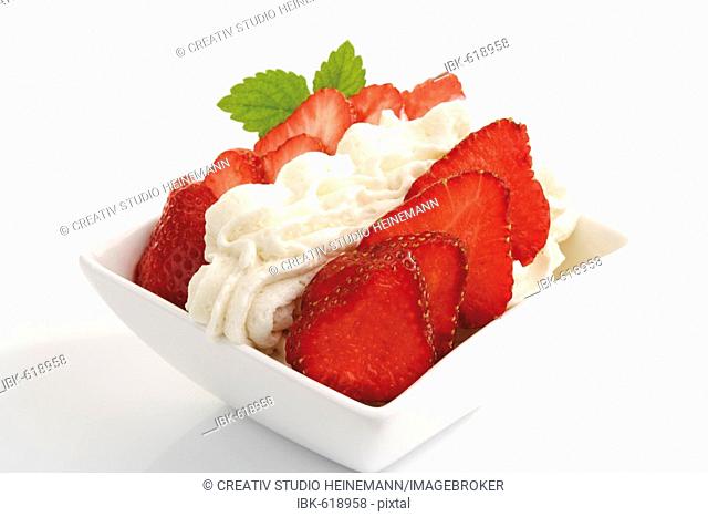 Strawberries with whipped cream in a bowl