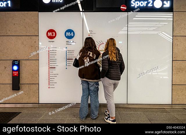 Copenhagen, Denmark Two young girls look at a Metro map in the Copenhagen Metro system