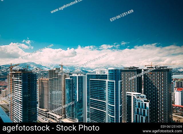 New Residential Multi-storey Houses On Blue Sky. Real Estate, Development Industry. highrise houses Elevated View Cityscape Skyline. Light Lighting